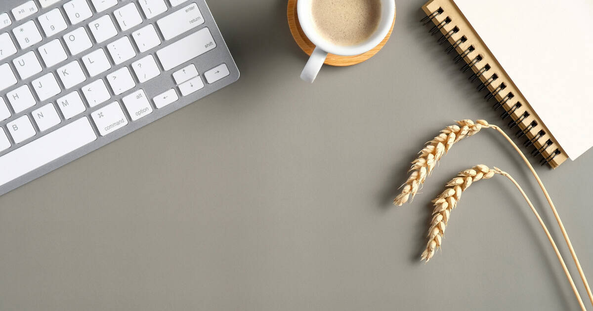 Desk with keyboard, book, and coffee