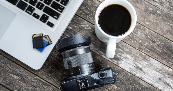 Laptop, camera, and coffee